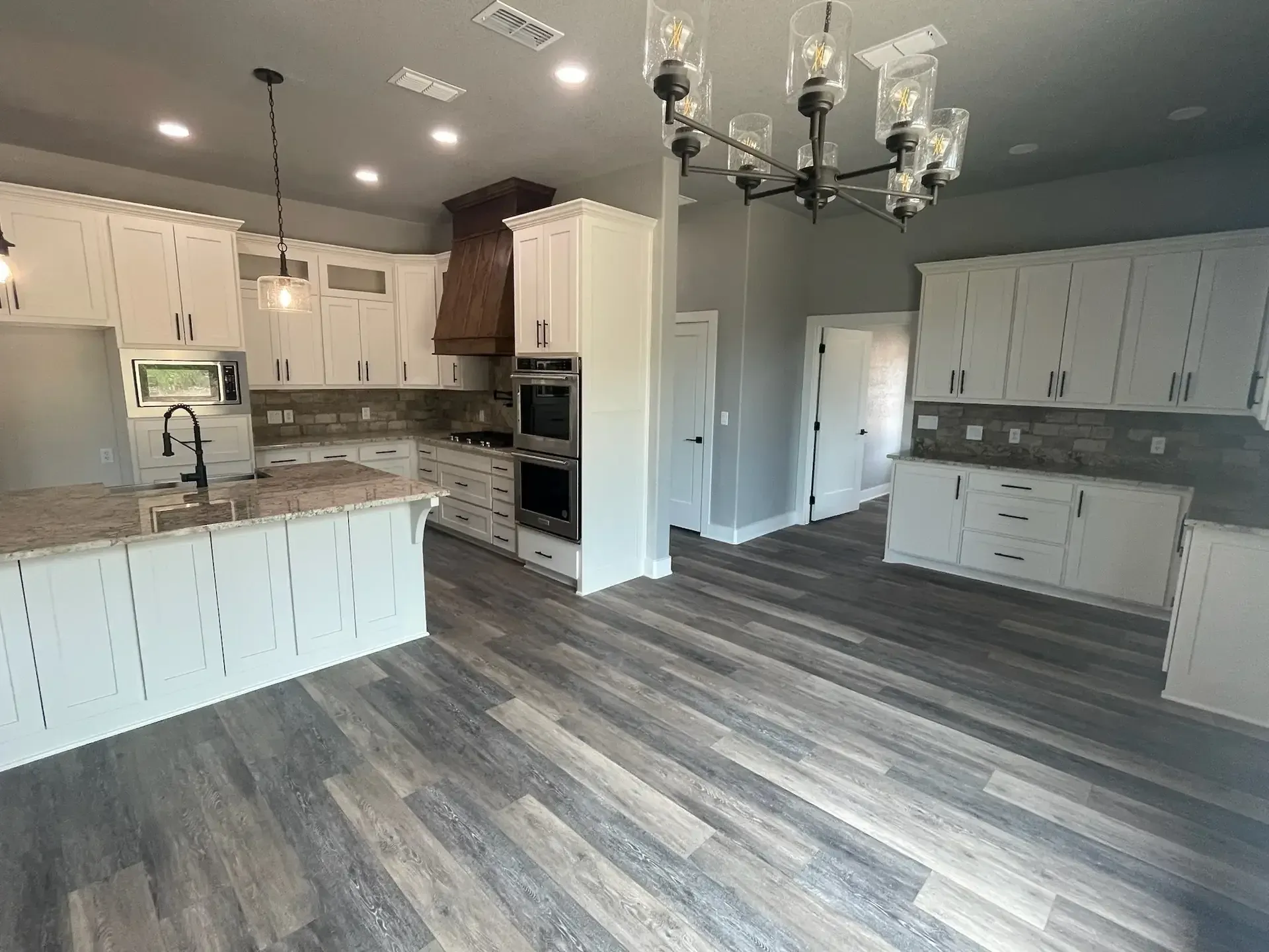 Gray flooring and white cabinet kitchen interior