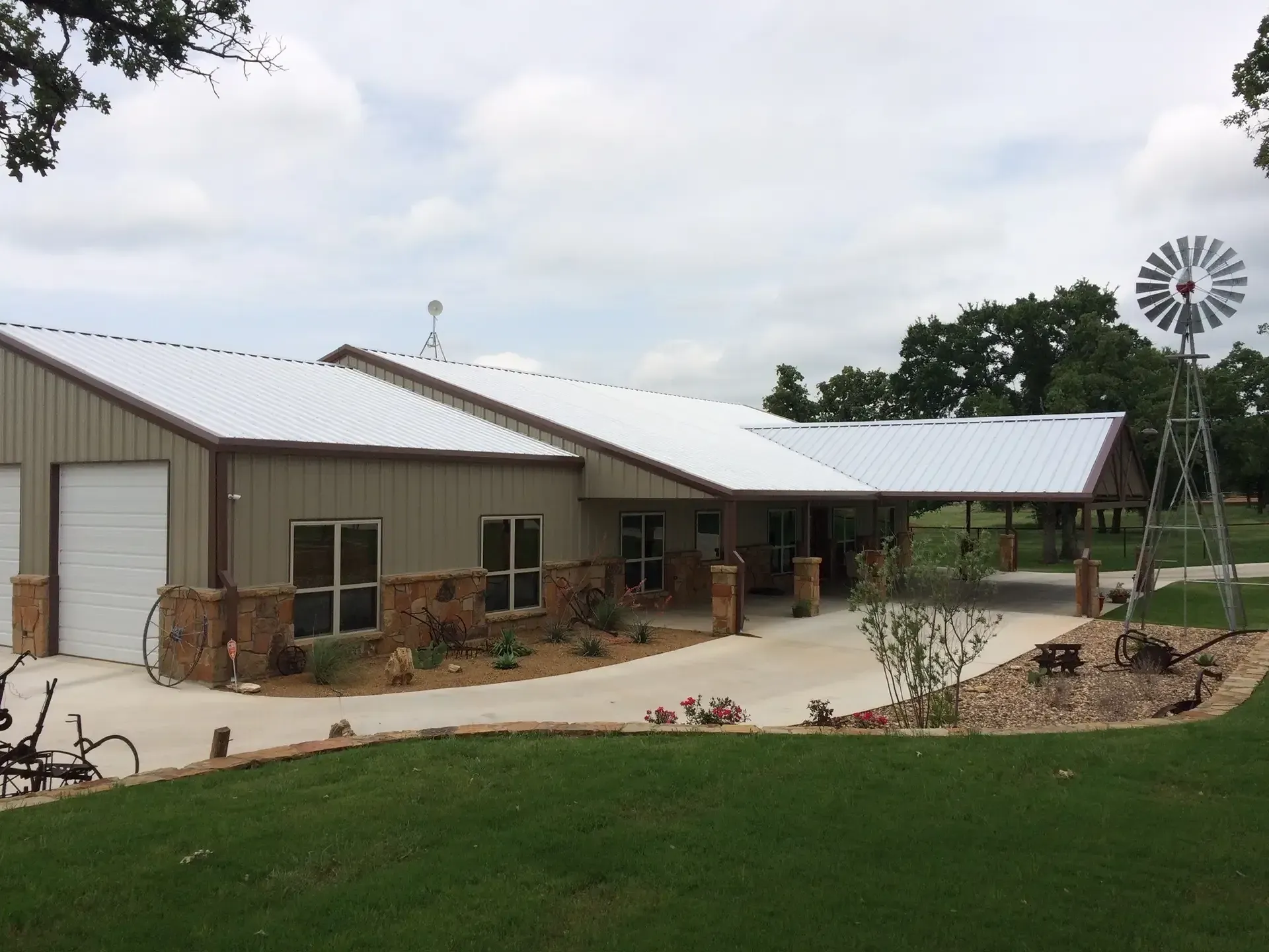 brown barndominium with tan walls and brown stone decrative siding