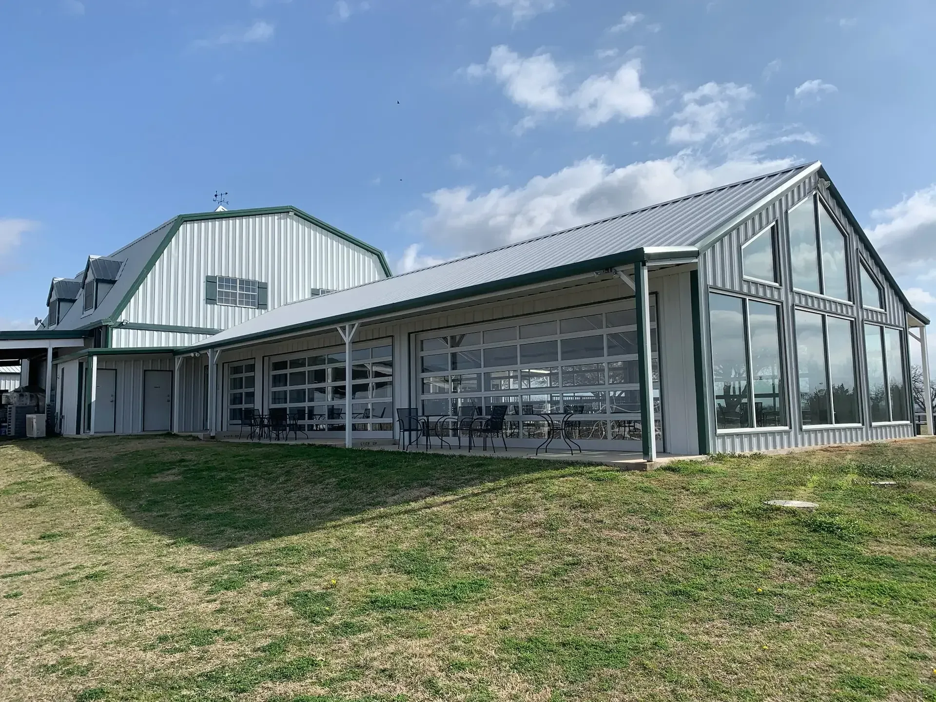Long glass addition to a barn shaped barndominium