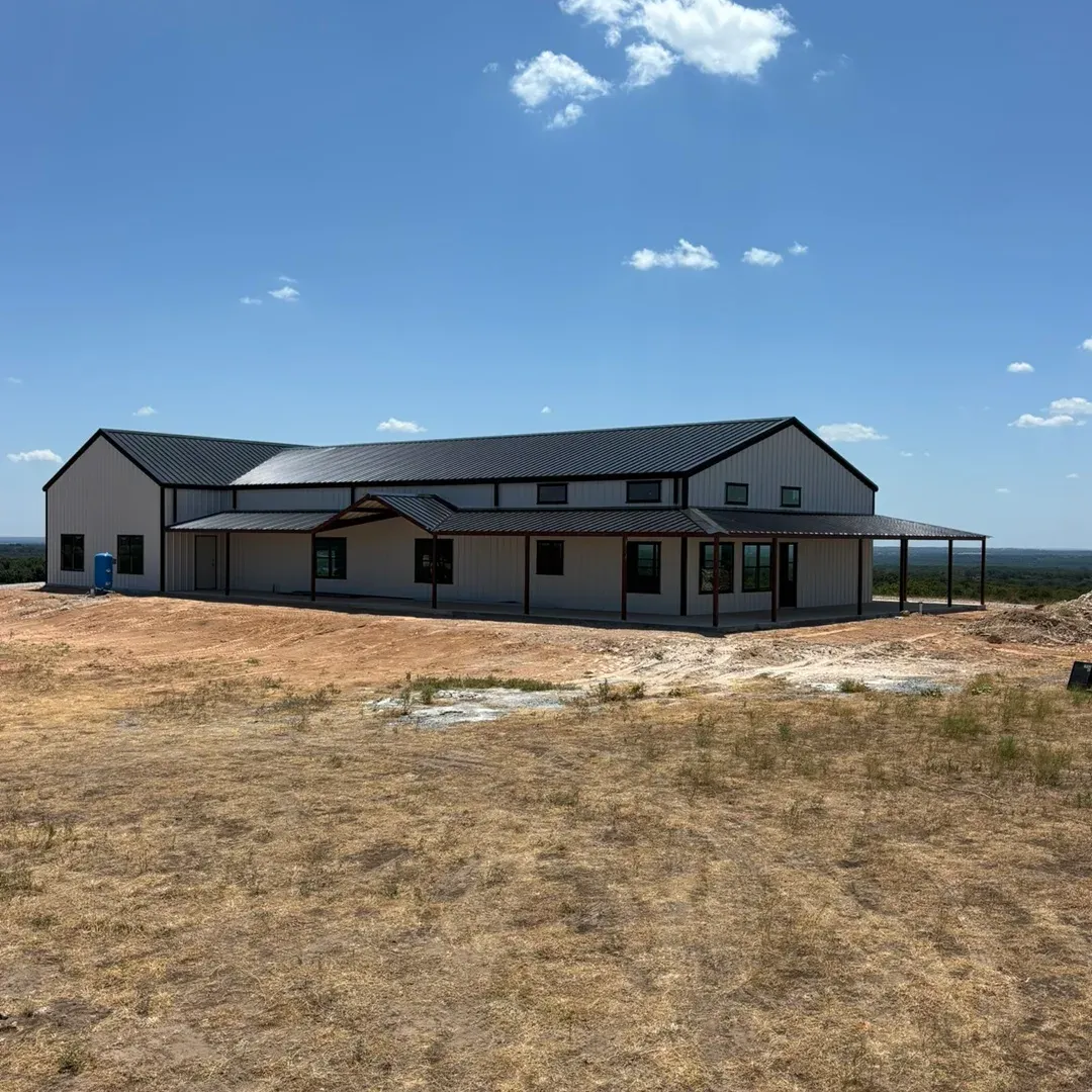 Black and white barndominium with porch